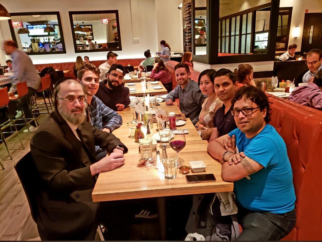 Founders and investors seated along a long restaurant table